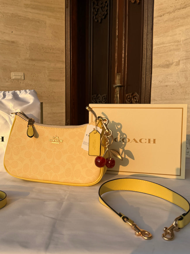 COACH LIGHT PASTEL YELLOW BAG WITH CHERRY CHARM AND 2 STRIPS Main Image