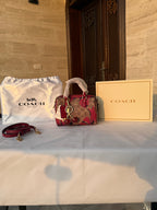 COACH BROWN AND RED PATTERN BAG WITH CHERRY CHARM
