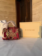 COACH BROWN AND RED PATTERN BAG WITH CHERRY CHARM