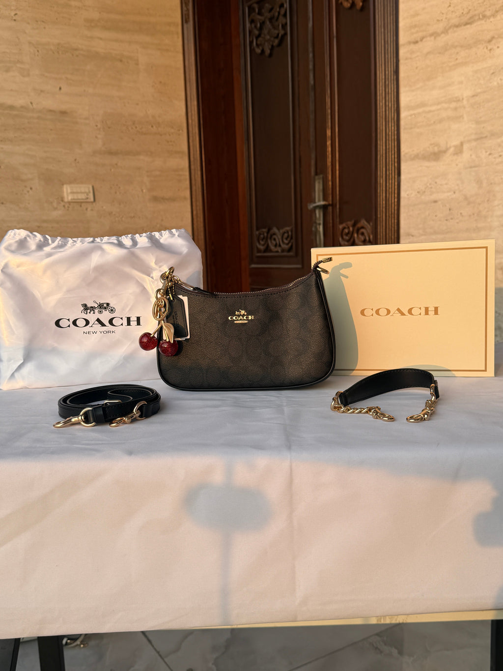 COACH BLACK PATTERN BAG WITH CHERRY CHARM AND 2 STRIPS