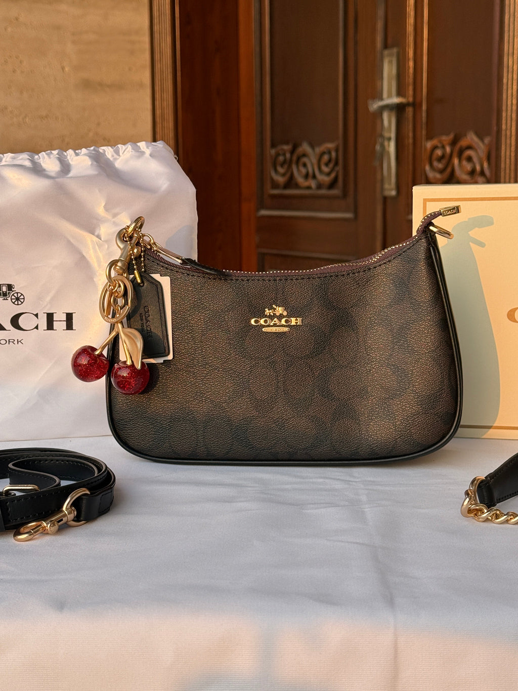 COACH BLACK PATTERN BAG WITH CHERRY CHARM AND 2 STRIPS