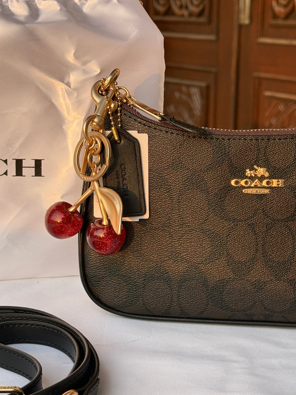 COACH BLACK PATTERN BAG WITH CHERRY CHARM AND 2 STRIPS