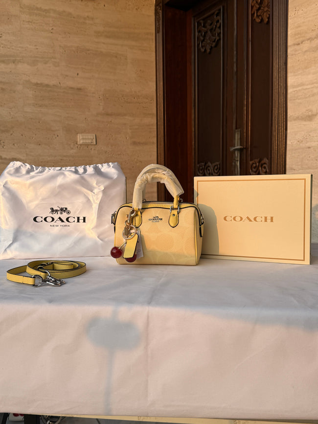 COACH LIGHT PASTEL YELLOW BAG WITH CHERRY CHARM Hover Image