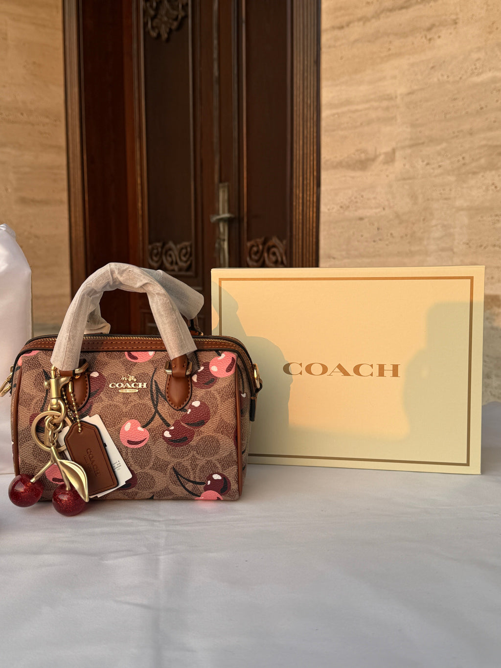 COACH LIGHT BROWN /TAN BASE CHERRY PATTERN BAG WITH CHERRY CHARM