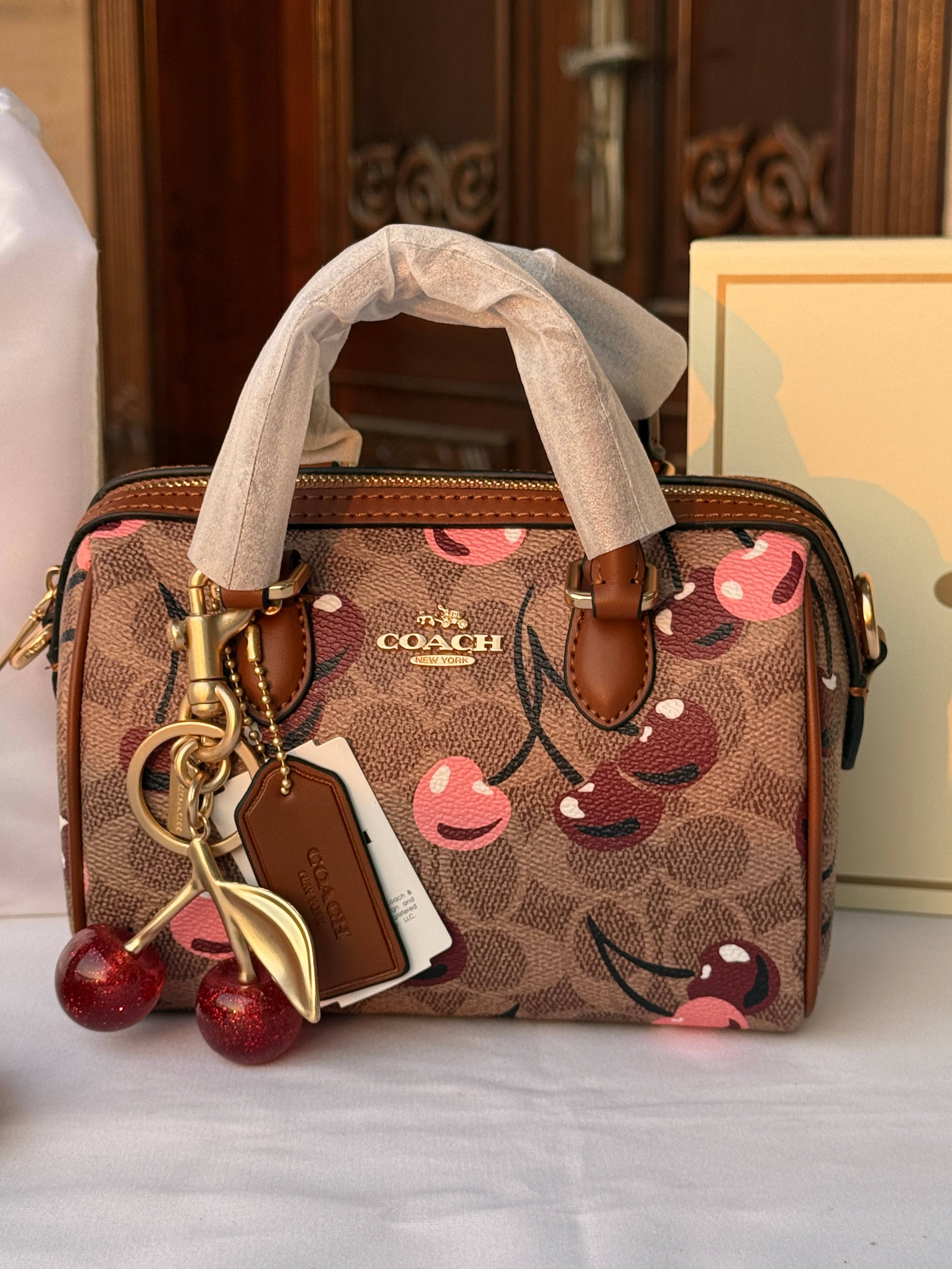 COACH LIGHT BROWN /TAN BASE CHERRY PATTERN BAG WITH CHERRY CHARM